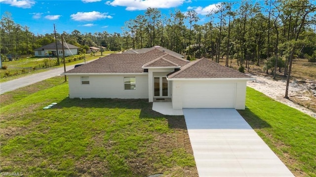 view of front of property featuring a front yard and a garage