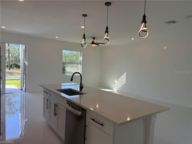 kitchen featuring sink, white cabinetry, dishwasher, pendant lighting, and a kitchen island with sink