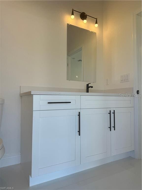 bathroom featuring toilet and vanity