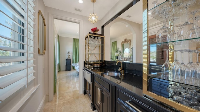 interior space with hanging light fixtures, a healthy amount of sunlight, and sink