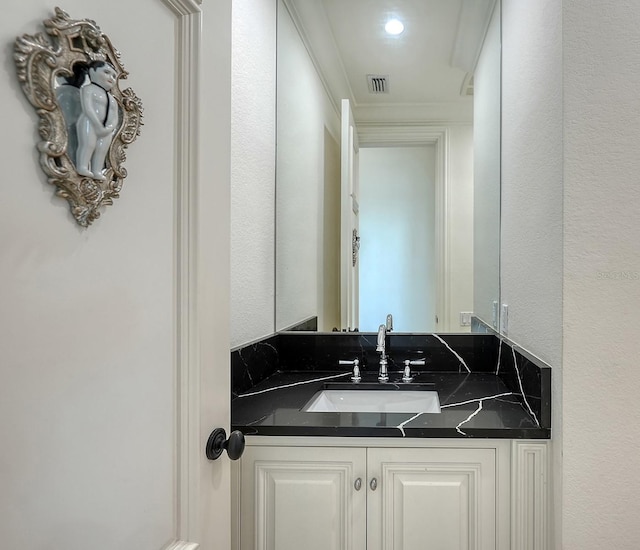 bathroom featuring vanity and ornamental molding