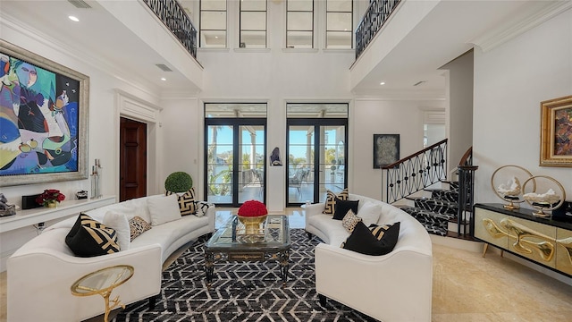 living room with crown molding, french doors, and a high ceiling