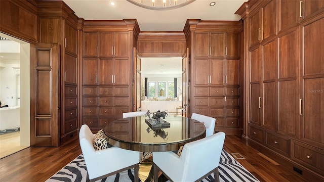 dining area featuring crown molding and dark hardwood / wood-style flooring