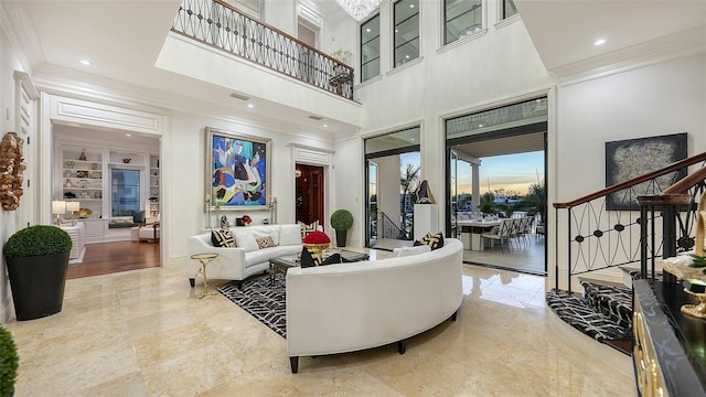 living room featuring built in shelves and crown molding