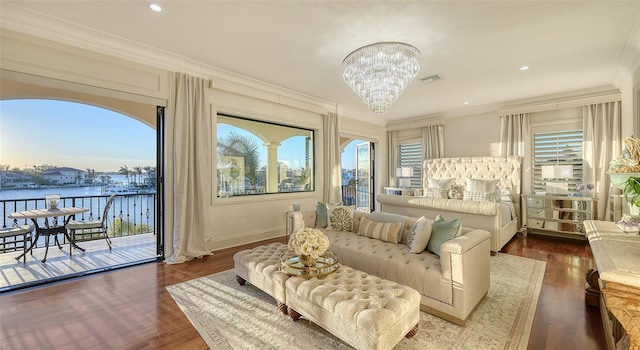 bedroom with access to outside, a water view, dark hardwood / wood-style floors, and ornamental molding