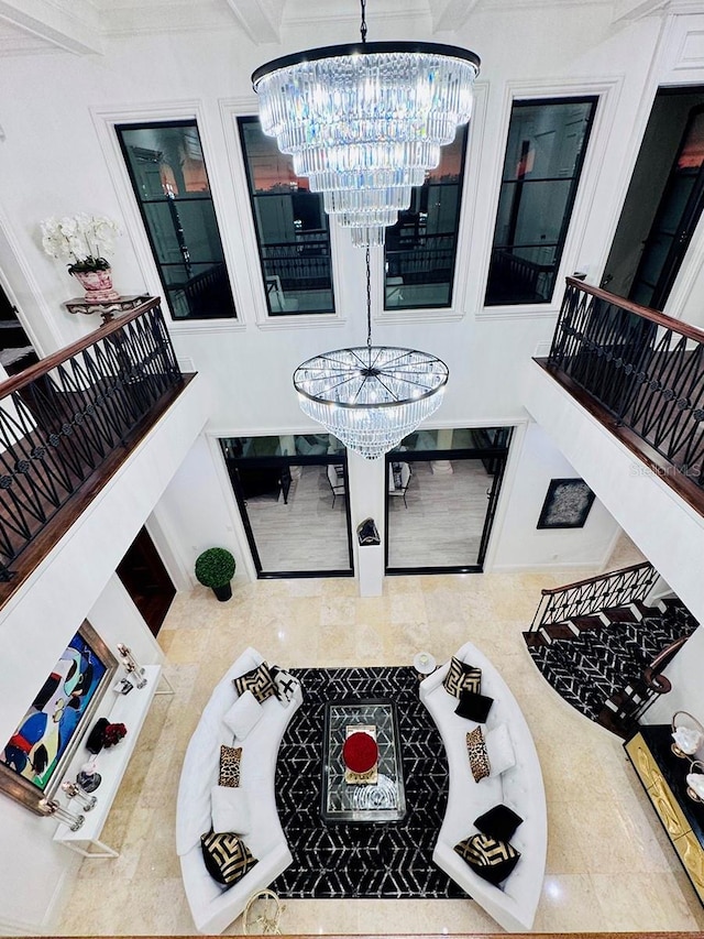 interior space with beam ceiling and a notable chandelier