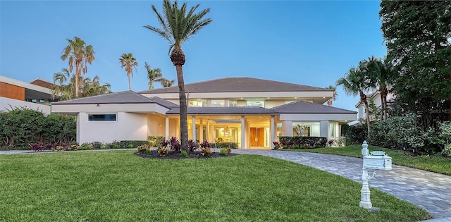 prairie-style home featuring a front lawn