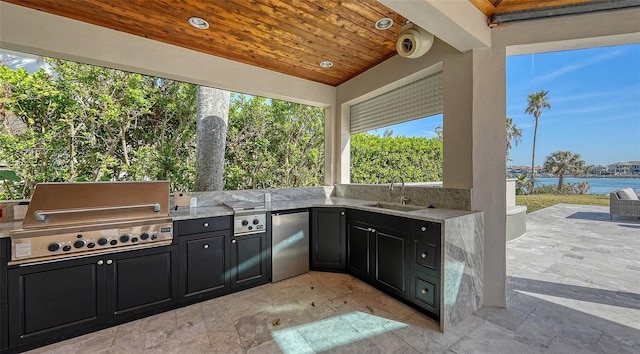 view of patio / terrace featuring sink, a water view, area for grilling, and grilling area