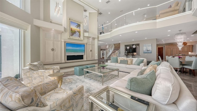 living room with a towering ceiling and a chandelier