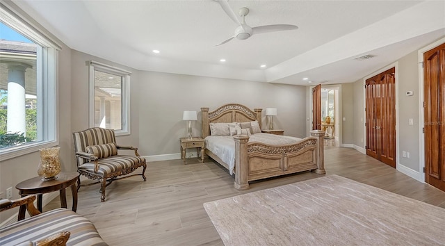 bedroom featuring ceiling fan and multiple windows