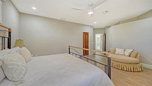 bedroom with ensuite bathroom, ceiling fan, and light hardwood / wood-style floors