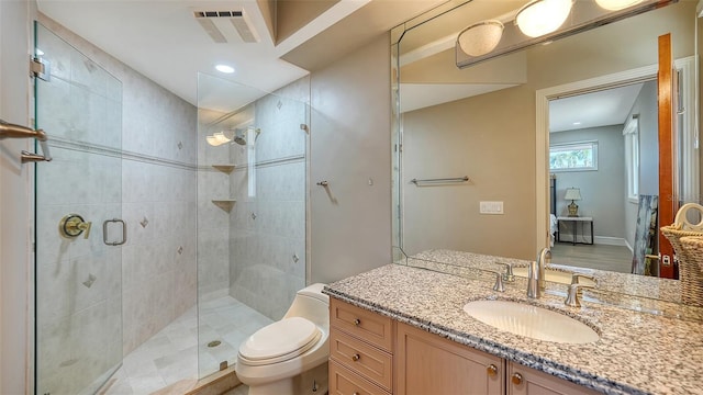 bathroom with toilet, an enclosed shower, and vanity