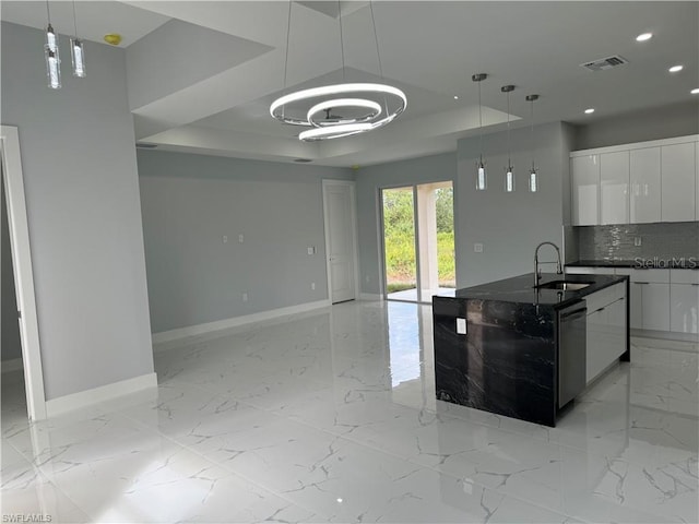 kitchen with dishwasher, pendant lighting, sink, white cabinetry, and backsplash