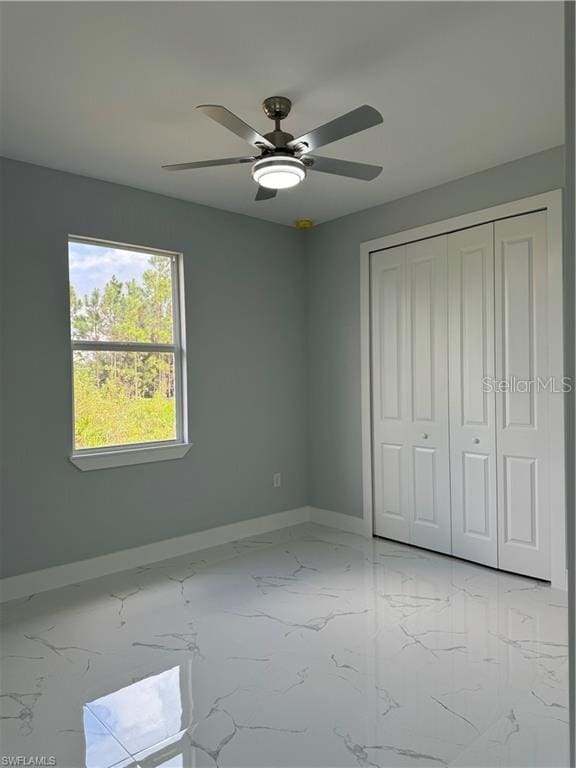 unfurnished bedroom with a closet and ceiling fan