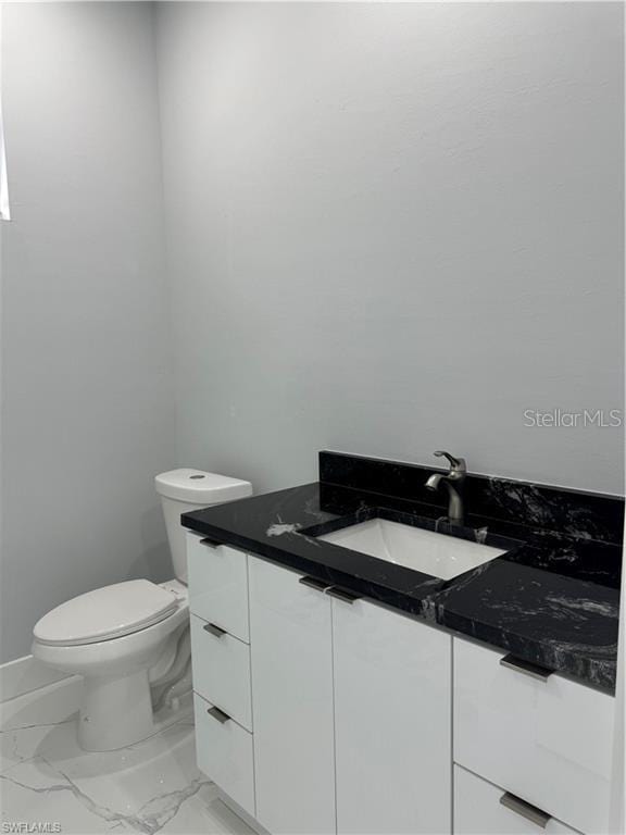 bathroom with toilet and vanity