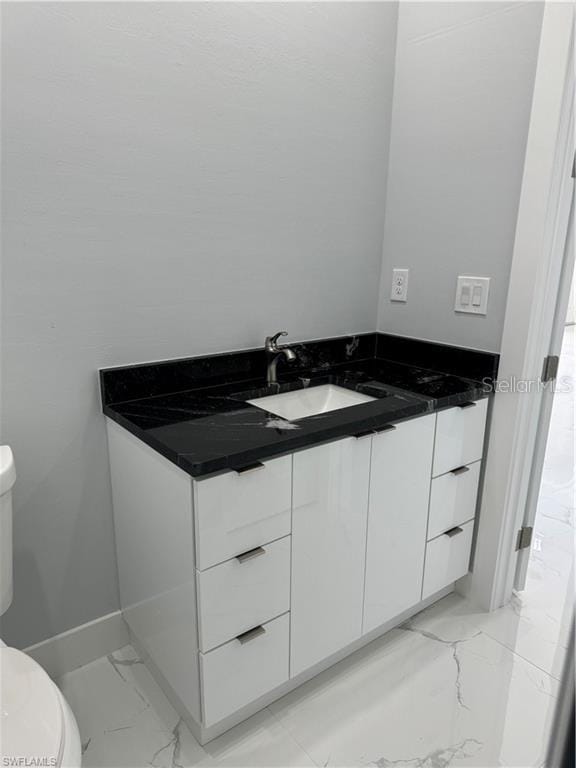 bathroom featuring toilet and vanity