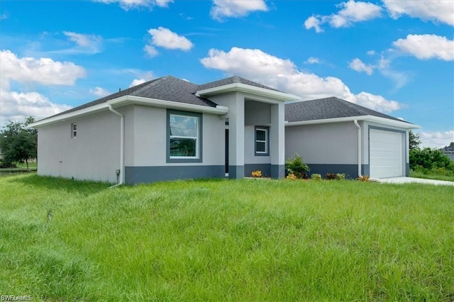 view of front of house with a garage and a front lawn