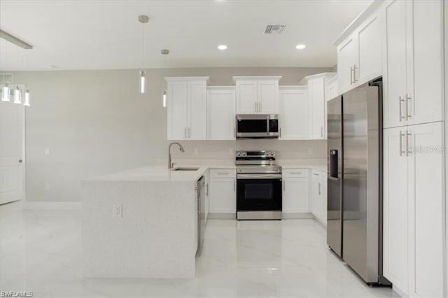 kitchen featuring kitchen peninsula, appliances with stainless steel finishes, sink, pendant lighting, and white cabinetry