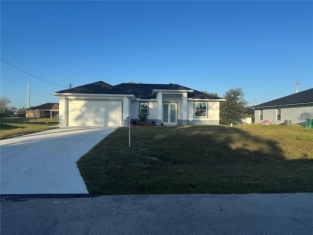 view of front of property with a garage, central AC unit, and a front lawn