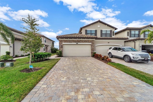 mediterranean / spanish home featuring a garage and a front yard