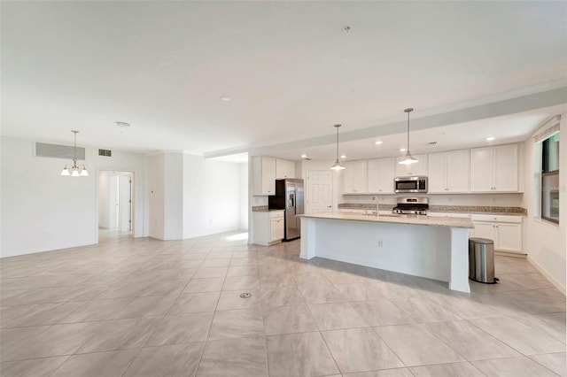 kitchen featuring white cabinets, decorative light fixtures, stainless steel appliances, and a chandelier