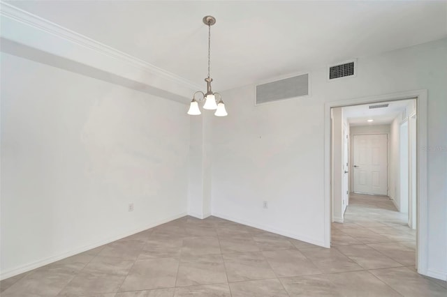 spare room featuring a notable chandelier and light tile patterned flooring