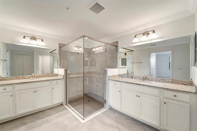 bathroom featuring tile patterned flooring, vanity, a shower with door, and crown molding