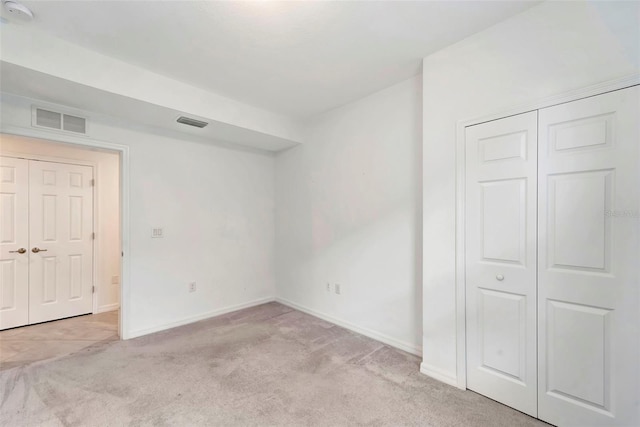 unfurnished bedroom featuring light carpet