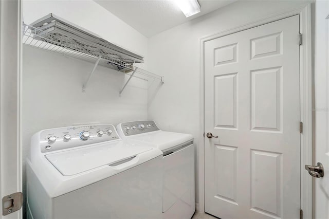 clothes washing area featuring washer and clothes dryer