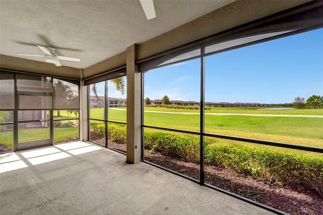 unfurnished sunroom with ceiling fan