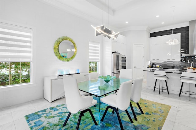 dining space featuring ornamental molding