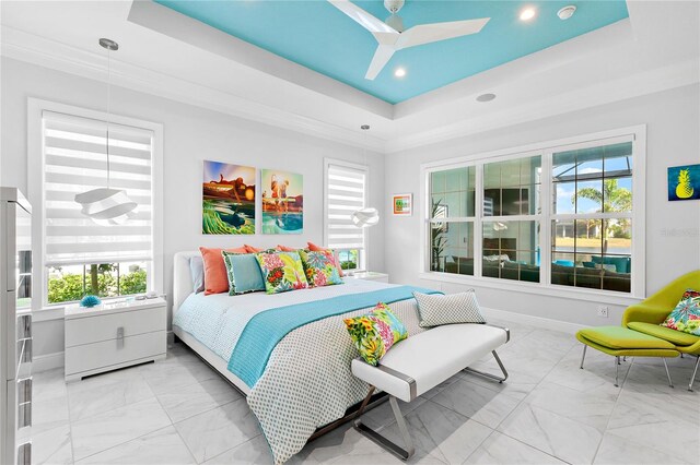 bedroom featuring a tray ceiling and ceiling fan