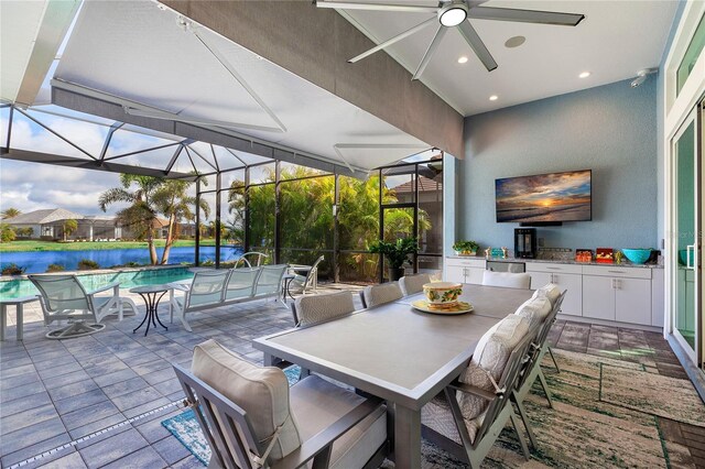 view of patio / terrace with ceiling fan and a lanai