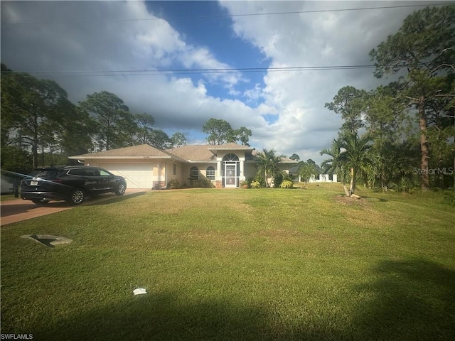 view of front of house with a front yard and a garage