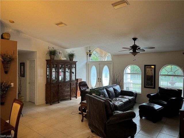 living room featuring ceiling fan, french doors, lofted ceiling, and light tile patterned floors