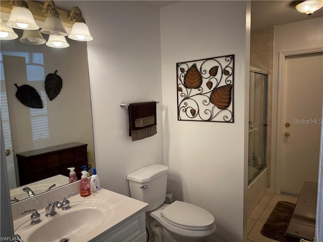 full bathroom featuring enclosed tub / shower combo, vanity, tile patterned floors, and toilet