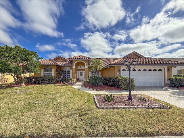 mediterranean / spanish home featuring a front lawn and a garage