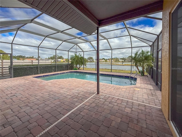 view of pool with a lanai, a patio area, and a water view