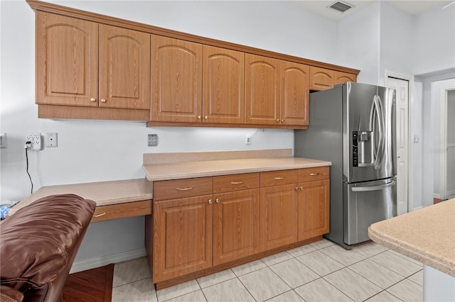 kitchen with stainless steel fridge and light tile patterned floors