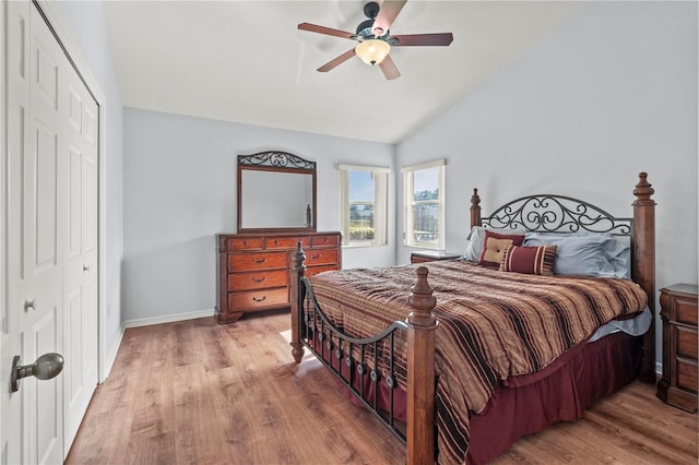 bedroom with hardwood / wood-style flooring, ceiling fan, lofted ceiling, and a closet