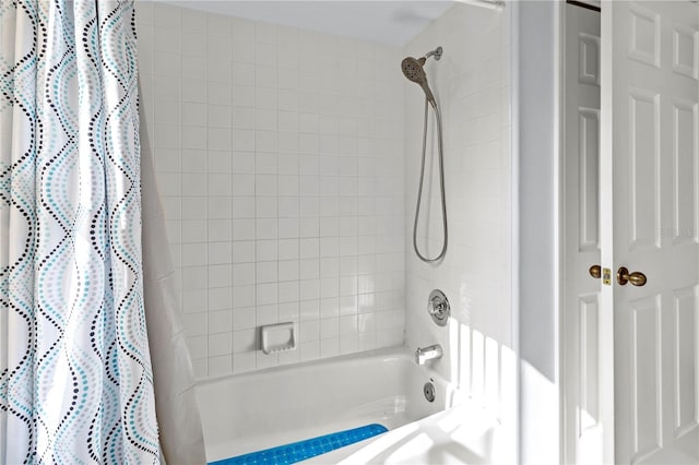 bathroom with shower / bathtub combination with curtain