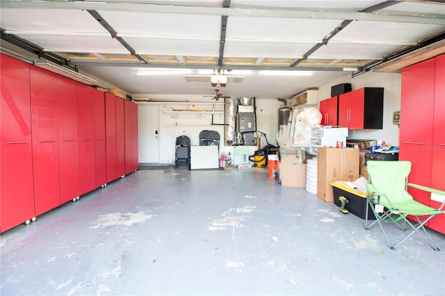 garage featuring heating unit and a garage door opener