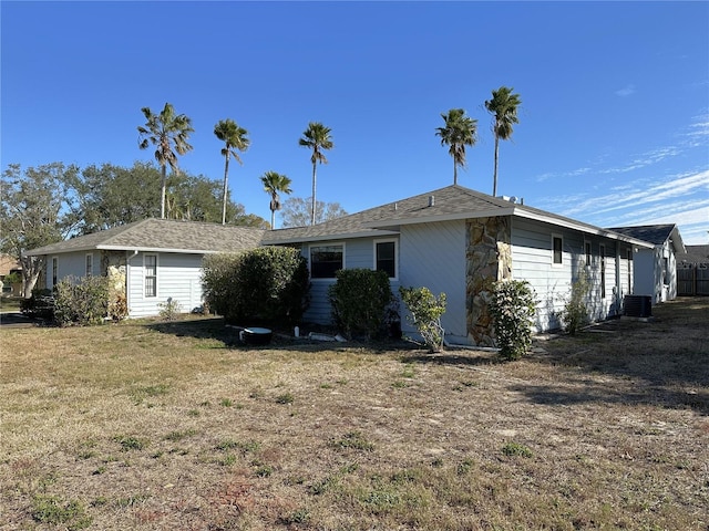 exterior space featuring cooling unit and a lawn