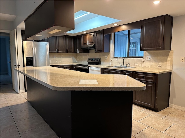 kitchen featuring a kitchen island, tasteful backsplash, sink, light tile patterned floors, and stainless steel appliances