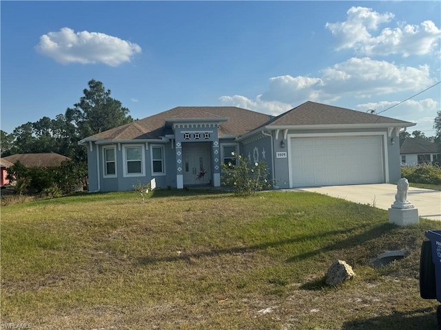 view of front of house featuring a front lawn and a garage