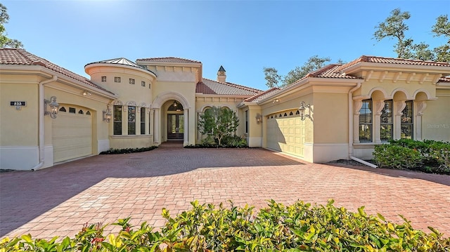 mediterranean / spanish house featuring a garage