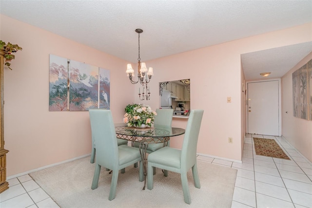 dining space with a textured ceiling, a notable chandelier, and light tile patterned flooring