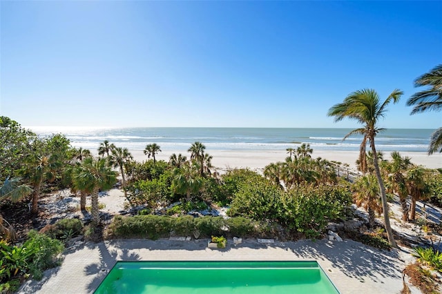 view of swimming pool with a view of the beach and a water view