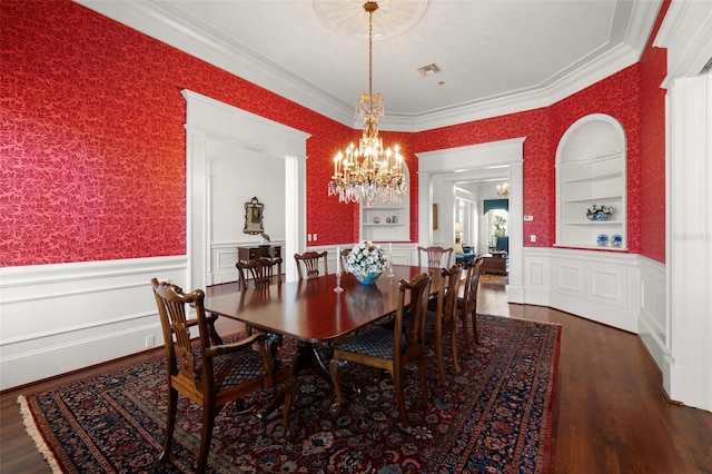 dining area with a chandelier, dark hardwood / wood-style flooring, built in features, and ornamental molding