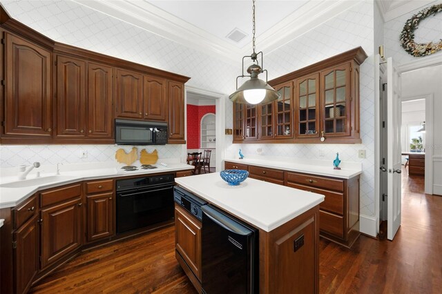 kitchen featuring black appliances, sink, hanging light fixtures, dark hardwood / wood-style floors, and ornamental molding